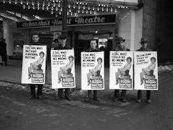 Men wearing signs advertising movie