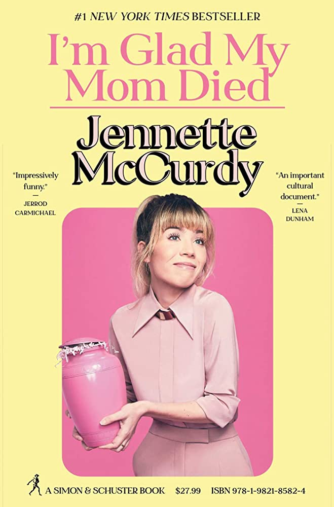 Cover for I'm Glad My Mom Died. The cover features McCurdy looking up and holding a pink urn with decorative paper spilling out. 
