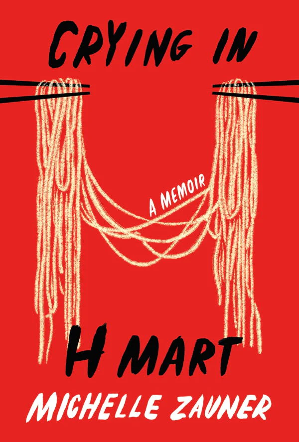 Cover for Crying in H Mart by Michelle Zauner. Two pairs of chopsticks hold intertwined noodles that drape down in the middle