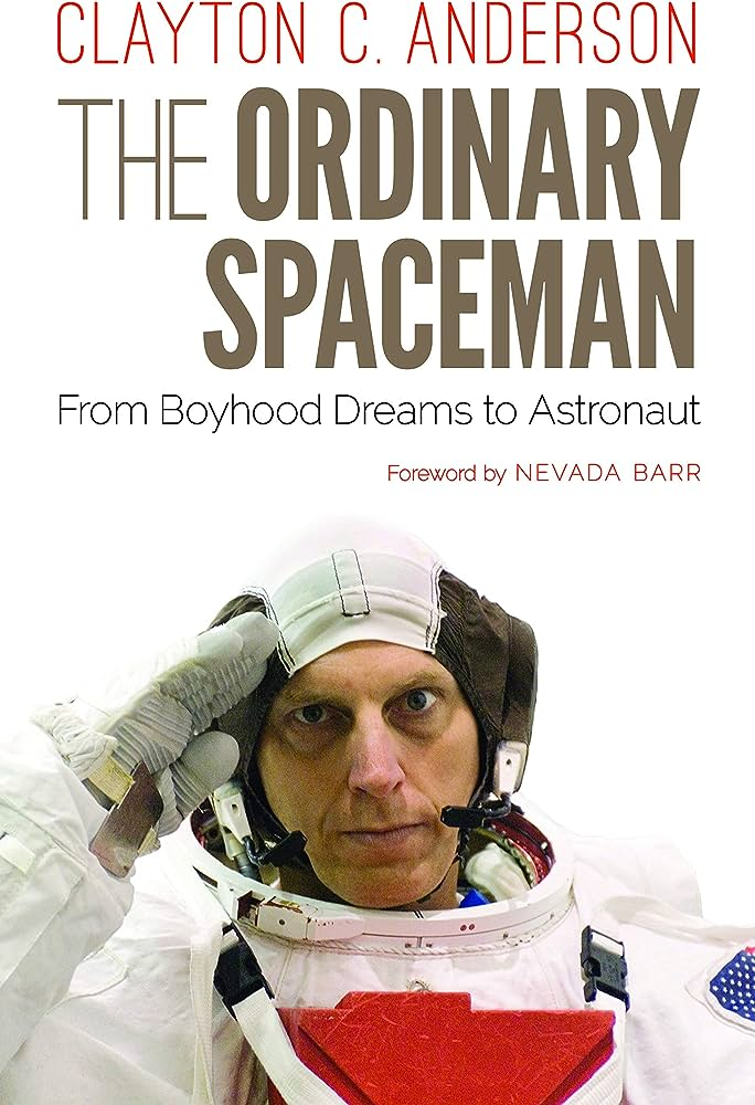 Cover for The Ordinary Spaceman by Clayton C. Anderson.
Anderson, a white man in a training space suit solemnly salutes the camera. 